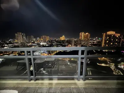 a view of a city skyline at night at FLAIR Condotel 1 BR Near MRT EDSA Shangrila Megamall Lightmall in Manila