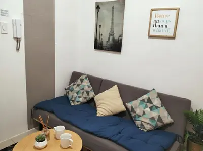 a couch with pillows on it in a living room at Mall of Asia - Aseana Residences in Manila
