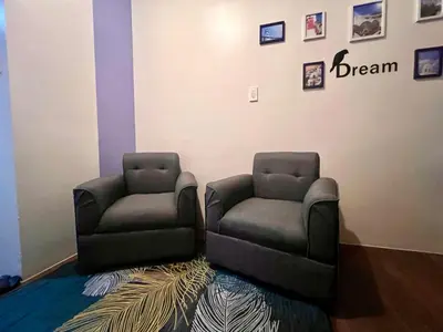 two chairs sitting next to each other in a room at Makati Business District Residences in Manila