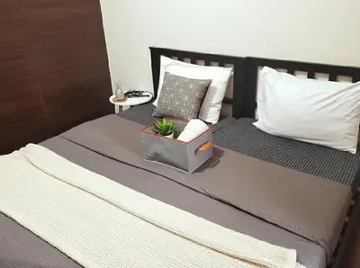 a bed with a potted plant sitting on top of it at Makati Business District Prime Accommodations in Manila