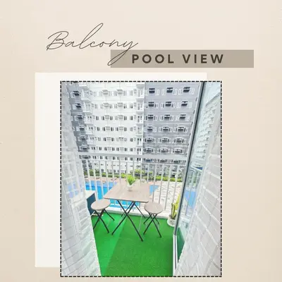 a balcony with a table and chairs and a building at Mytessuitehome in Manila