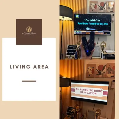 a picture of a living area with a tv and a sign at Mytessuitehome in Manila
