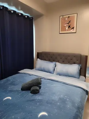 a bed with a stuffed animal on top of it at Pool View BP1043 in Manila