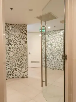 a room with a glass door and a wall at Pool View BP1043 in Manila