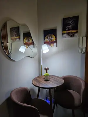 a room with a table and two chairs and a mirror at Modern Condotel 2Beds near MOA in Manila