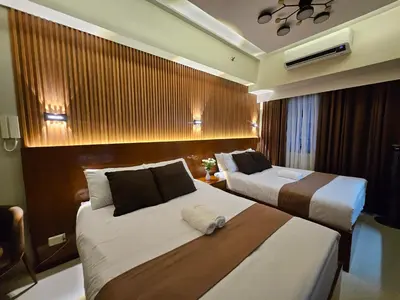 a hotel room with two beds in a room at Modern Condotel 2Beds near MOA in Manila