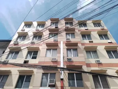 a tall building with windows on the side of it at BGC Suites EDSA Makati in Manila