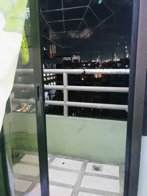 a view of the city from the window of a building at Somerset Condominium Kitchen Pool NAIA MOA LRT in Manila