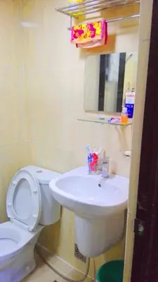 a bathroom with a white toilet and a sink at Somerset Condominium Kitchen Pool NAIA MOA LRT in Manila