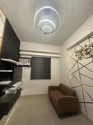 a living room with a couch and a ceiling at Leaf Residences Alabang Muntinlupa Condotel in Manila