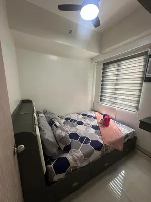 a bedroom with a bed in a room with a ceiling at Leaf Residences Alabang Muntinlupa Condotel in Manila