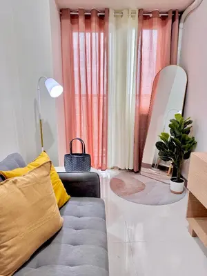 a living room with a couch and a mirror at Aesthetic Unit Near PICC and MOA in Manila