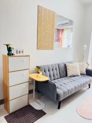 a living room with a couch and a table at Aesthetic Unit Near PICC and MOA in Manila