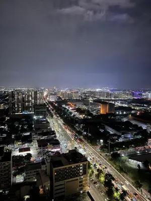 a city at night with traffic on a highway at Aesthetic Unit Near PICC and MOA in Manila