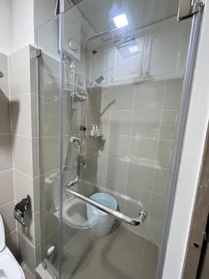 a shower with a glass door with a toilet at Aesthetic Unit Near PICC and MOA in Manila