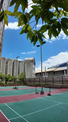 two tennis courts with buildings in the background at Venetian Panorama BGC Venice Grand Canal Apart ment, 4 Bedrooms, for 10 Guests in Manila