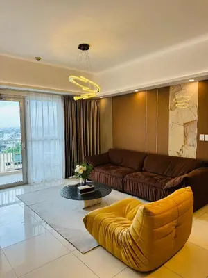 a living room with a couch and a table at Venetian Panorama BGC Venice Grand Canal Apart ment, 4 Bedrooms, for 10 Guests in Manila