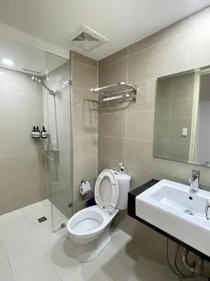 a bathroom with a toilet and a sink and a shower at Venetian Panorama BGC Venice Grand Canal Apart ment, 4 Bedrooms, for 10 Guests in Manila
