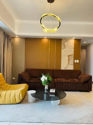 a living room with a couch and a table at Venetian Panorama BGC Venice Grand Canal Apart ment, 4 Bedrooms, for 10 Guests in Manila
