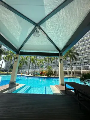 a swimming pool with a building in the background at Shell Residence Mall of Asia in Manila