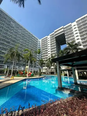 a large swimming pool in front of a large building at Shell Residence Mall of Asia in Manila