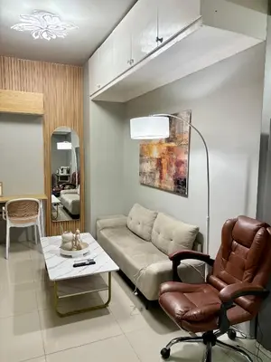 a living room with a couch and a table at Comfy Cozy Staycation in Manila