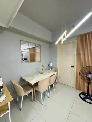 a dining room with a table and chairs at Comfy Cozy Staycation in Manila