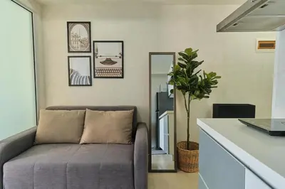 a living room with a couch in a kitchen at Bahamas Tower Azure Urban Resort Residences by Nestled Nook in Manila