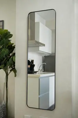 a mirror on a wall next to a kitchen at Bahamas Tower Azure Urban Resort Residences by Nestled Nook in Manila