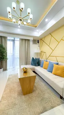 a living room with a couch and a table at CYLOS PLACE Manhattan Araneta Center 2BR with BALCONY in Manila