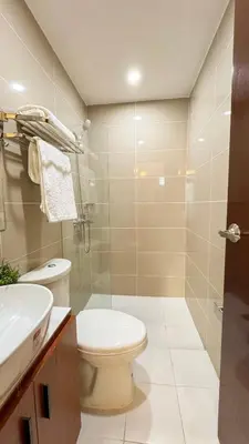 a bathroom with a toilet and a sink at CYLOS PLACE Manhattan Araneta Center 2BR with BALCONY in Manila