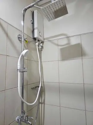 a shower with a shower head in a bathroom at SMDC Field REsidences condo unit in Manila