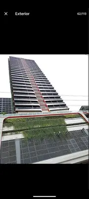 a large tall building with some grass in front of it at StayCation at Red Residence in Manila