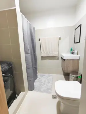 a bathroom with a toilet and a sink at StayCation at Red Residence in Manila