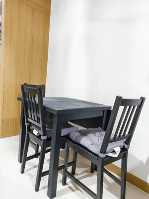 a black table and two chairs sitting next to it at StayCation at Red Residence in Manila