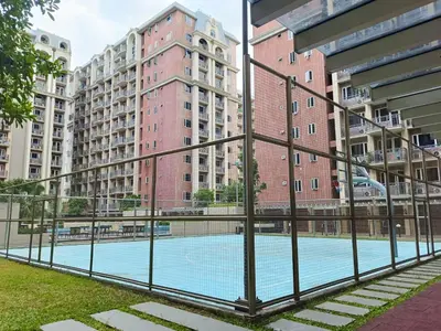 a swimming pool in a city with tall buildings at BP1043 Pool View Staycation Paranaque Pasay in Manila