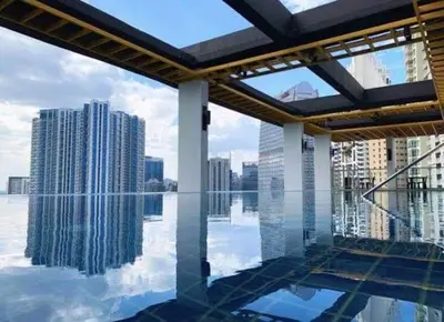 a view of the city from a pool in a building at Aura Luxe Stays at BCCT in Manila