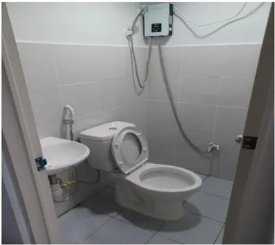 a bathroom with a toilet and a sink at AIr Hub Transient in Manila