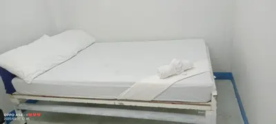 a white bed with white sheets and pillows at AIr Hub Transient in Manila