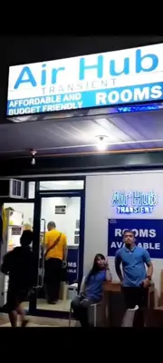 a group of people sitting in front of an air hump room at AIr Hub Transient in Manila