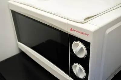 a white toaster oven with its door open at Manhattan Heights Modern Studio in Manila