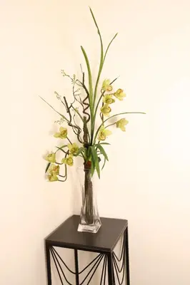 a vase of flowers sitting on a table at Home Away From Home in Manila