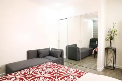 a bedroom with a bed and a mirror at Home Away From Home in Manila