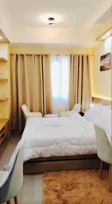 a bedroom with two beds and a window at Morena Suite in Dasmariñas