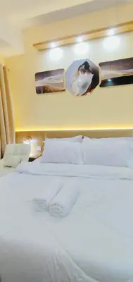 a bedroom with a white bed with two towels on it at Morena Suite in Dasmariñas