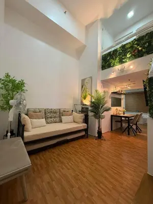 a living room with a couch and a table at Trendy 3BR Loft Condo along EDSA in Manila