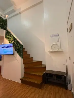 a stairway with a clock on the wall at Trendy 3BR Loft Condo along EDSA in Manila