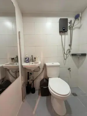 a bathroom with a toilet and a sink at Trendy 3BR Loft Condo along EDSA in Manila