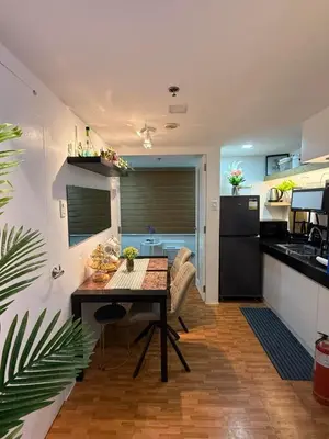 a kitchen and dining room with a table in a room at Trendy 3BR Loft Condo along EDSA in Manila