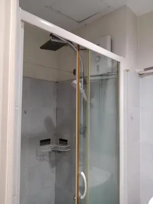 a shower with a glass door in a bathroom at Sea Residence Tower EF by Theresa P in Manila